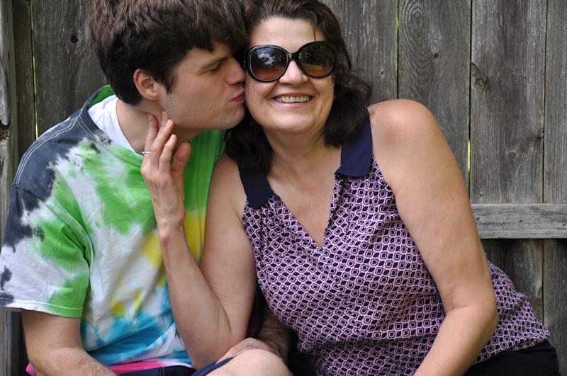 Son kissing his mother on the cheek